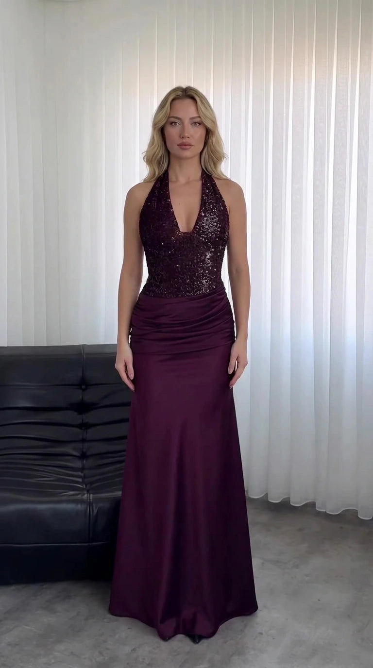 Model wearing Burgundy halter neck sequin and satin maxi gown front view