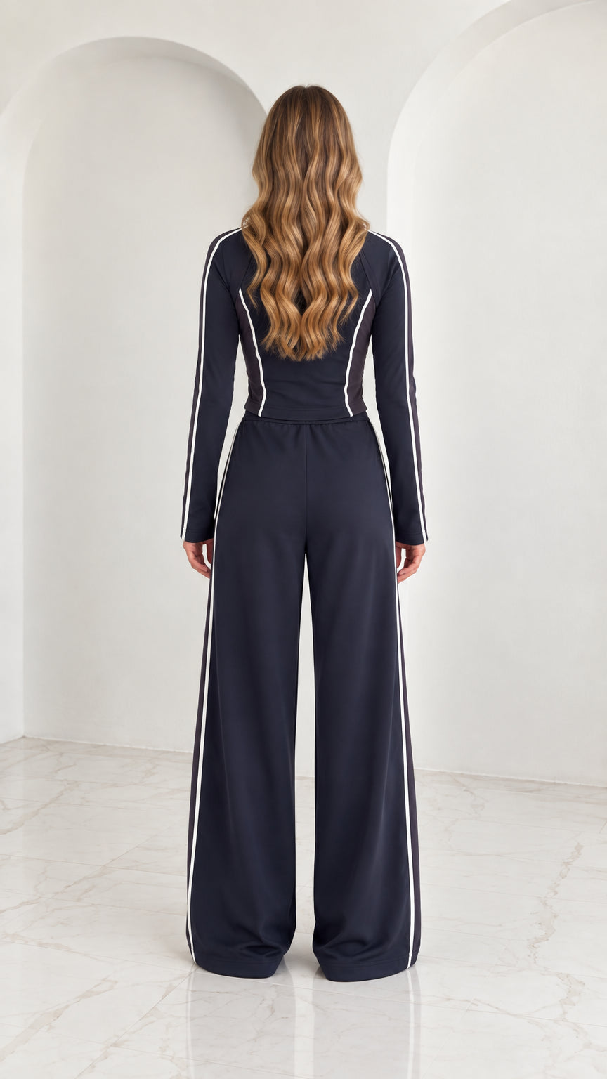Back view of model wearing Navy Blue tracksuit showing stand collar and contoured lines