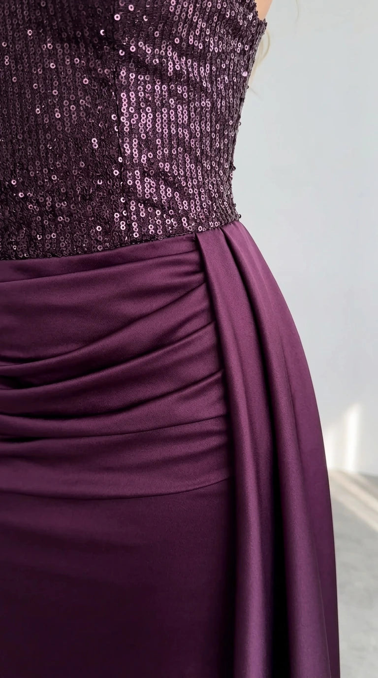 Close up of Burgundy sequin bodice and gathered ruched satin waist detailing