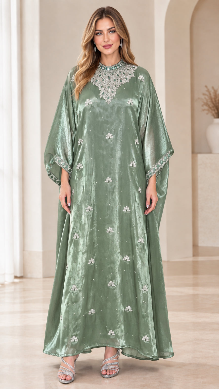 Model wearing sage green velvet kaftan maxi dress with beaded jewel neckline